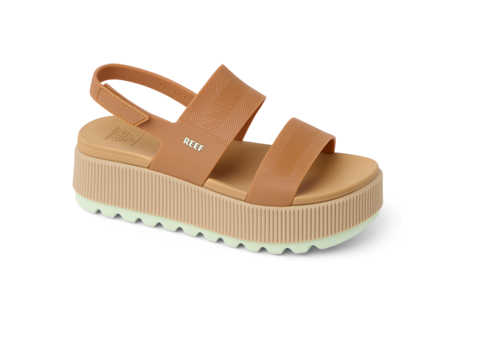 Tan platform sandal with 'REEF' branding on a white background