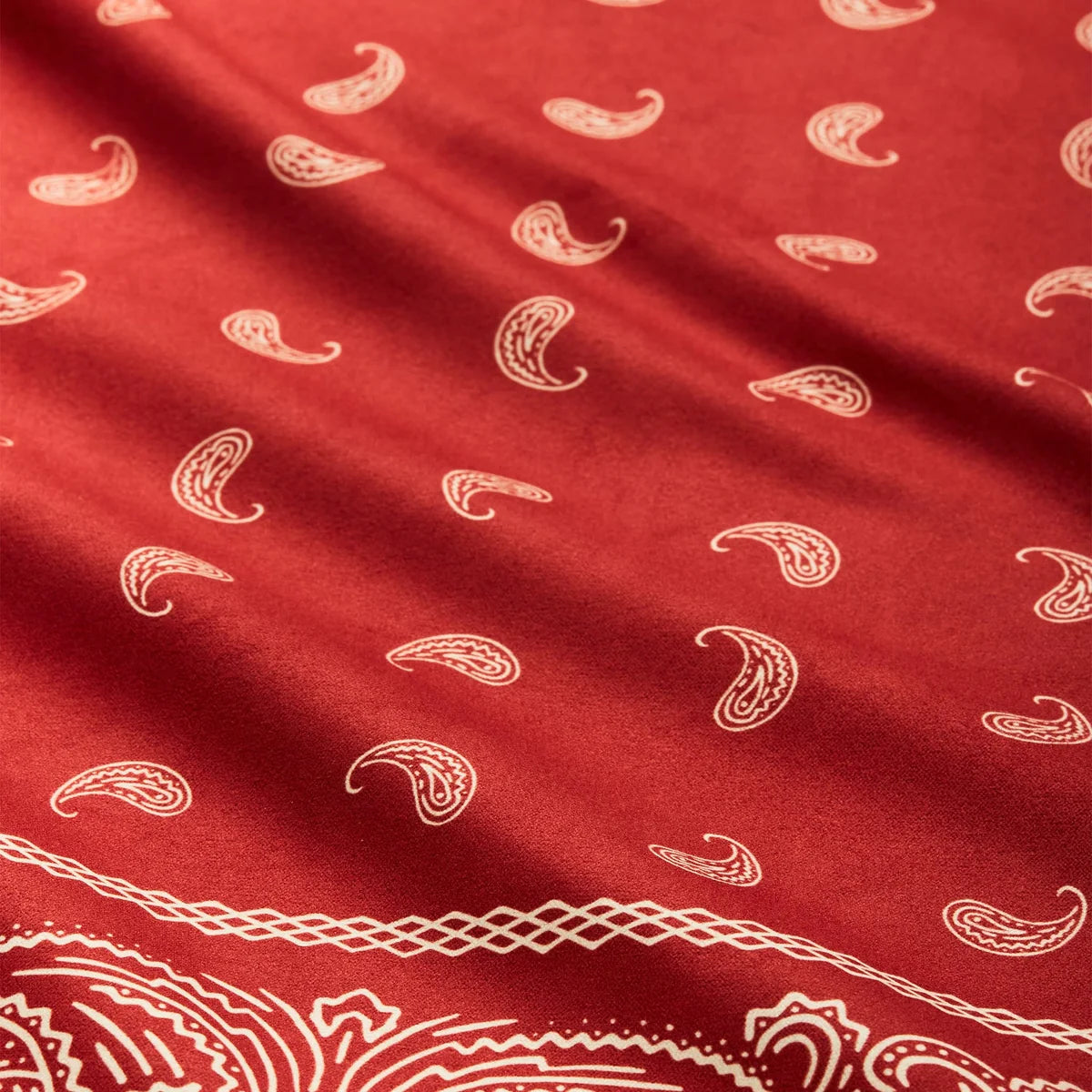 Red fabric with white paisley pattern