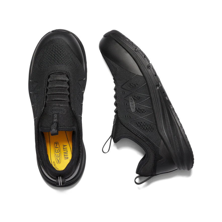 Black sneakers with a yellow sole on a white background