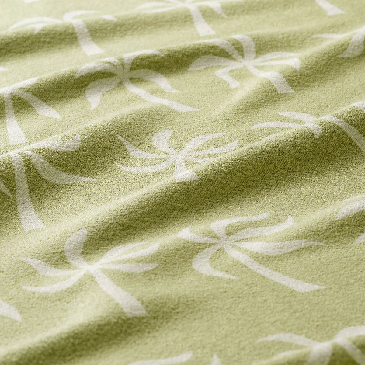 Close-up of green fabric with white floral pattern
