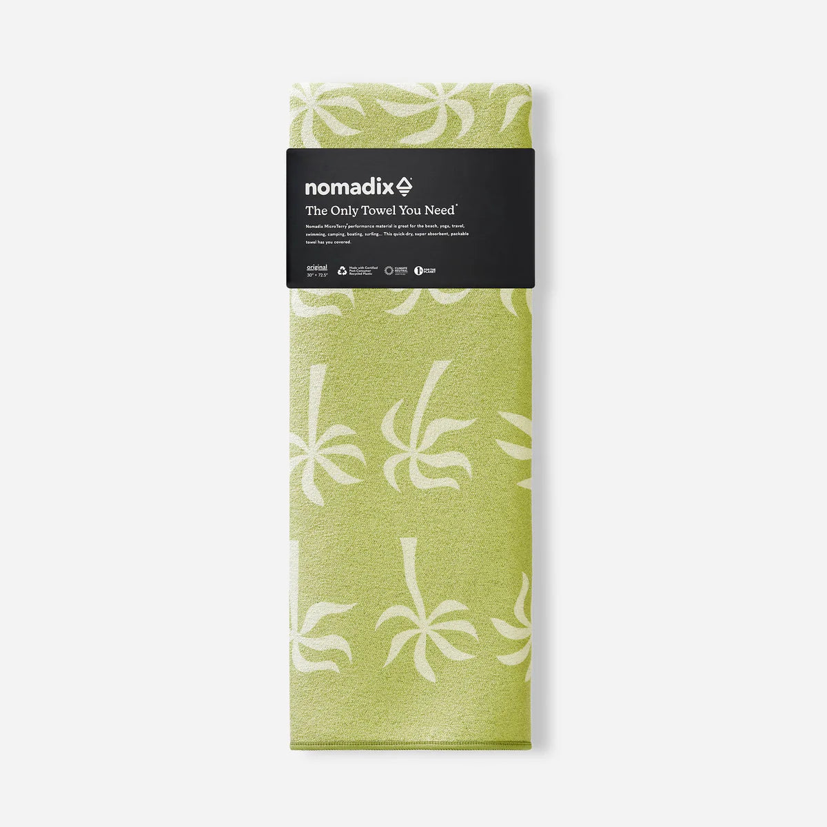 Green towel with white floral pattern in packaging on a white background