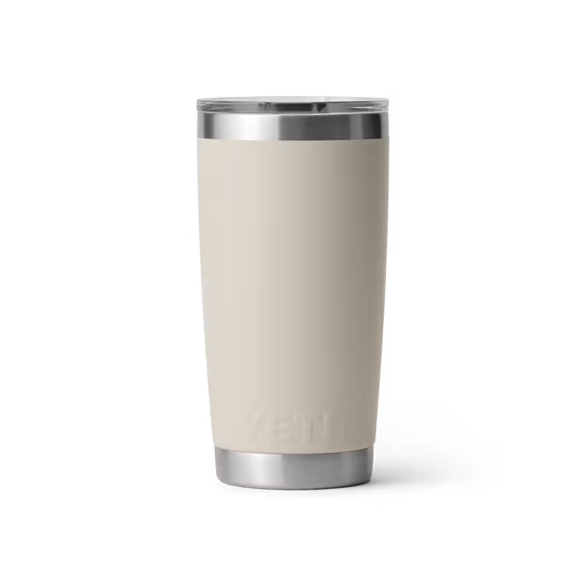 Beige tumbler with silver rim on a white background