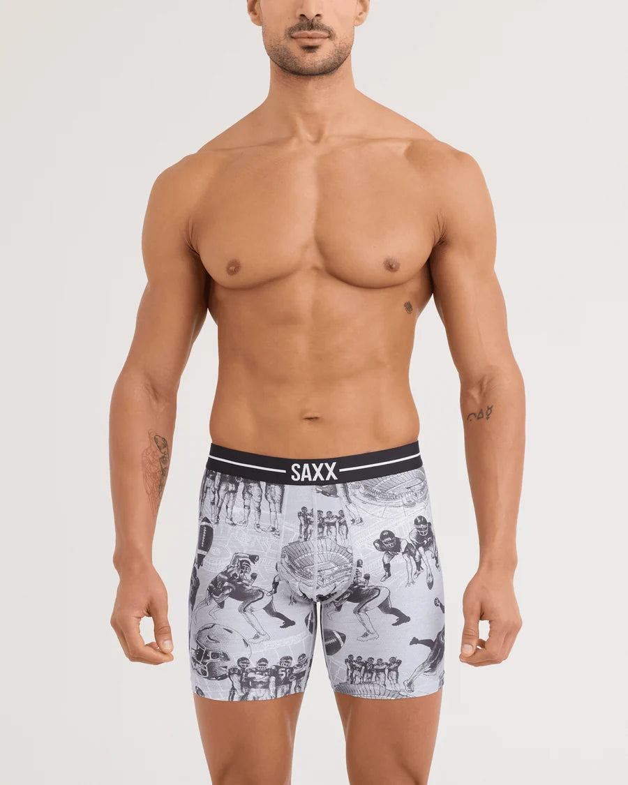 Man wearing SAXX underwear with a graphic design on a plain background