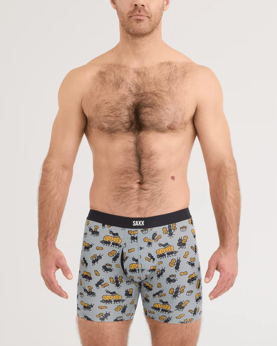 Man wearing boxer briefs with a cartoon dog pattern on a plain background