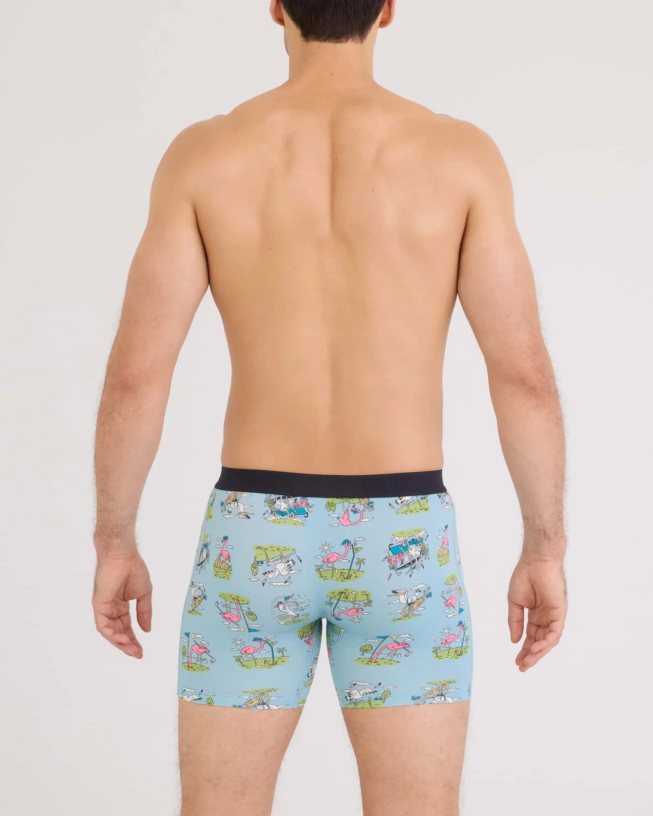 Man wearing colorful patterned underwear on a plain background