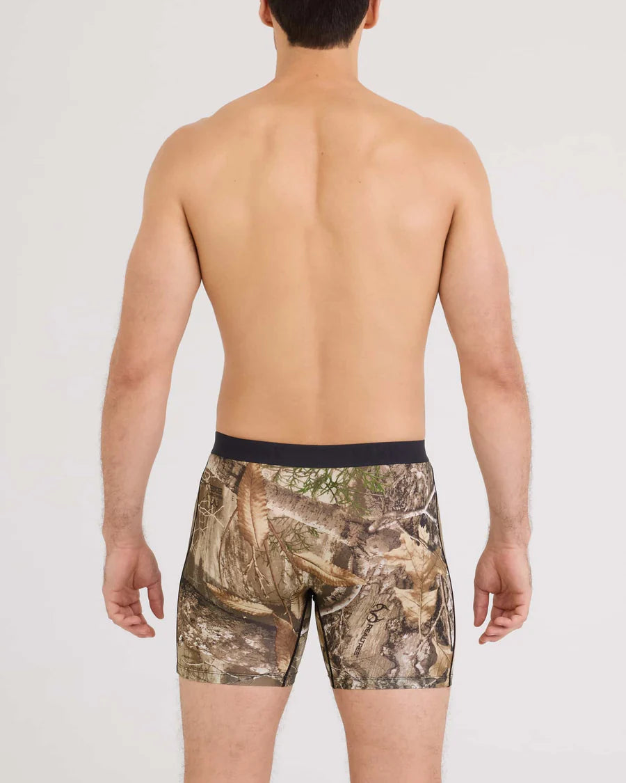 Man wearing camouflage boxer briefs on a plain background