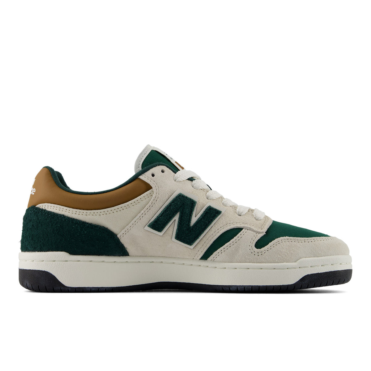 A New Balance sneaker in off-white suede and dark green suede, featuring a tan leather collar, white laces, and a thick white midsole with a black outsole.