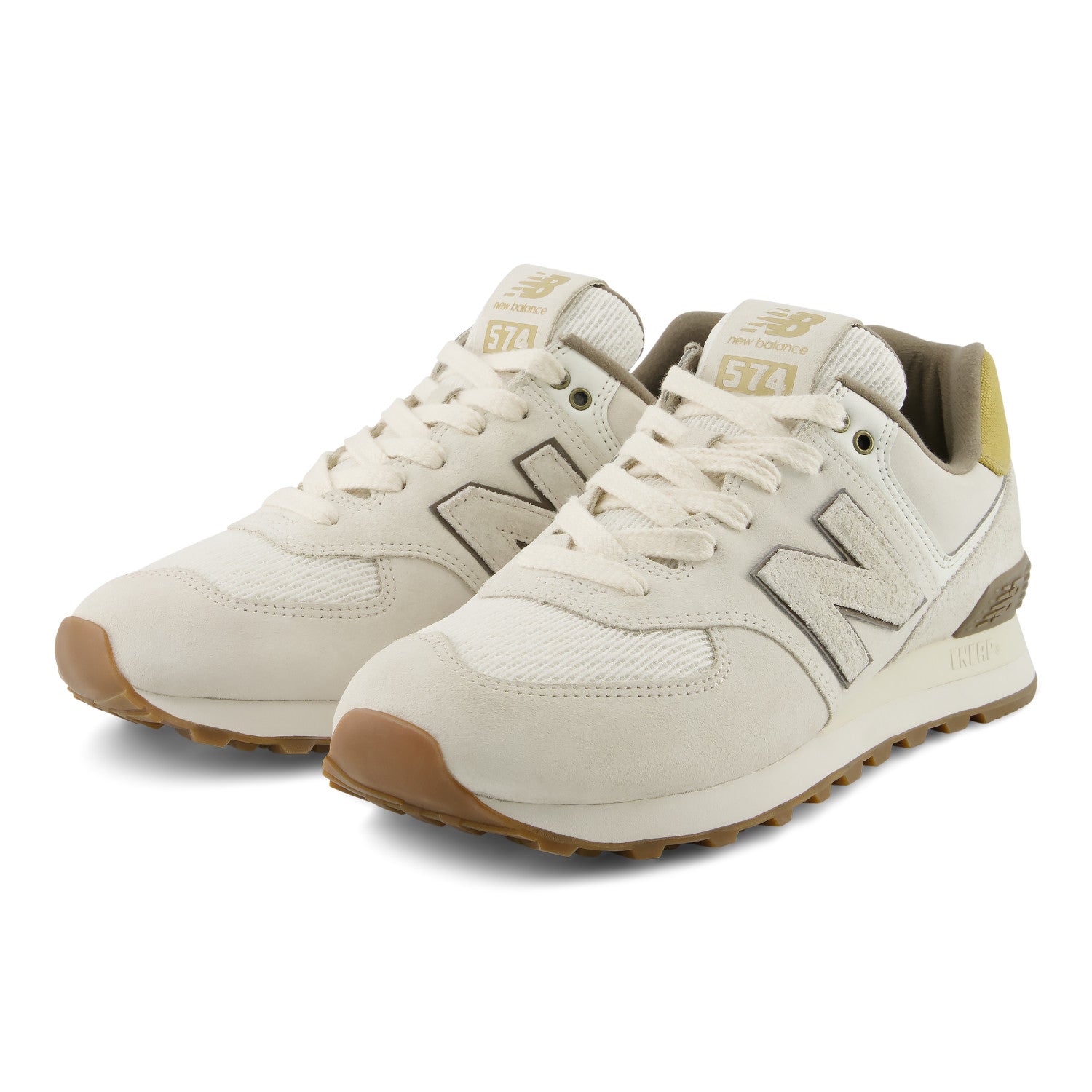 Pair of beige sneakers with brown soles on a white background