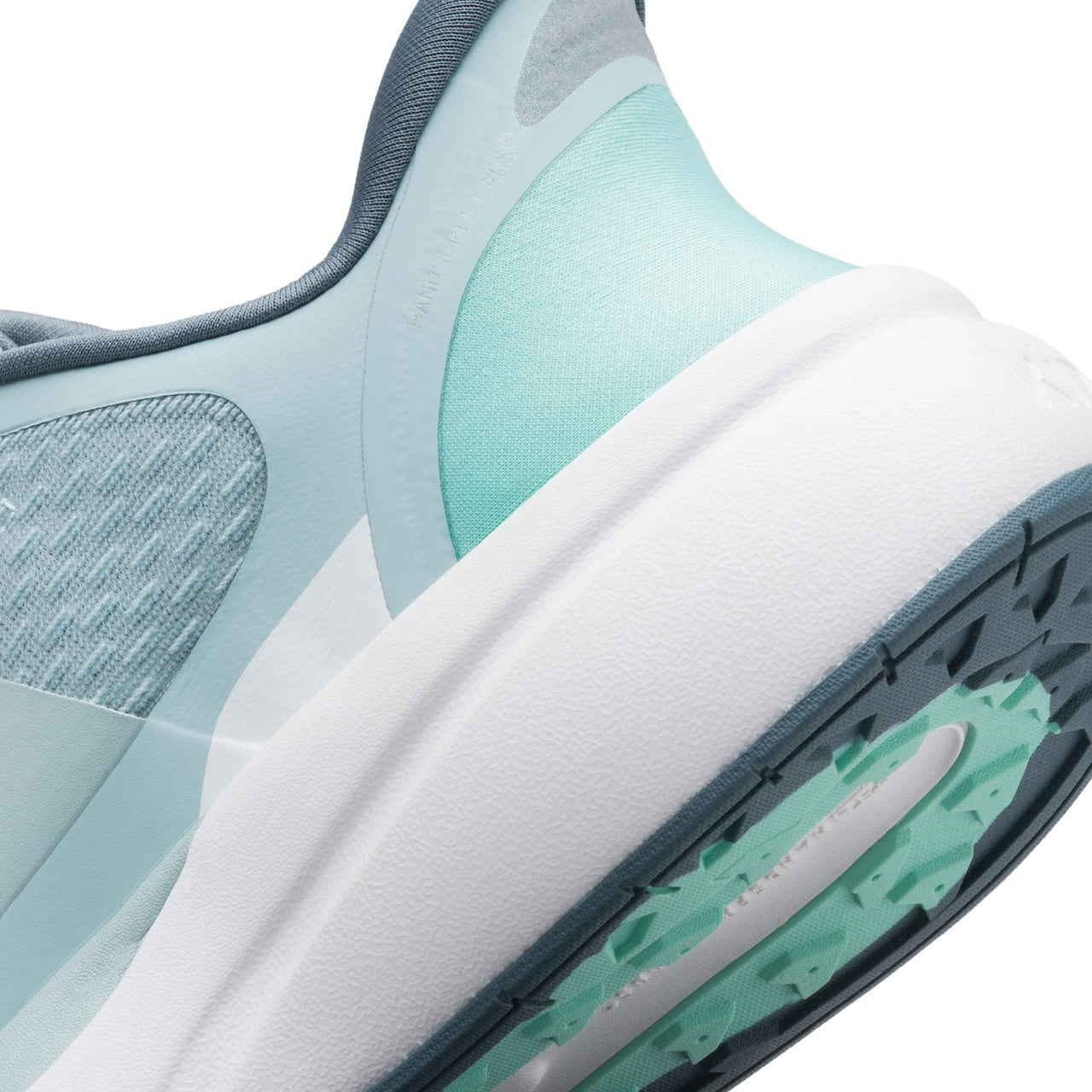 Close-up of a sneaker with light blue and gray design on a white background