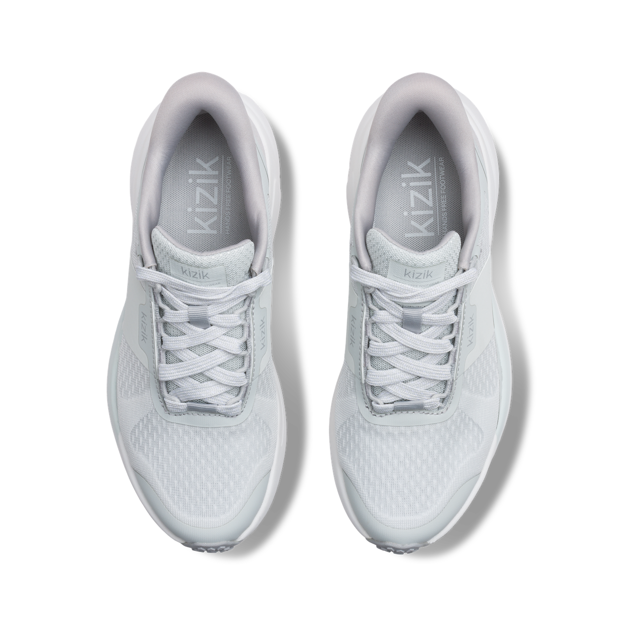 Pair of white sneakers with 'kizik' branding on a white background