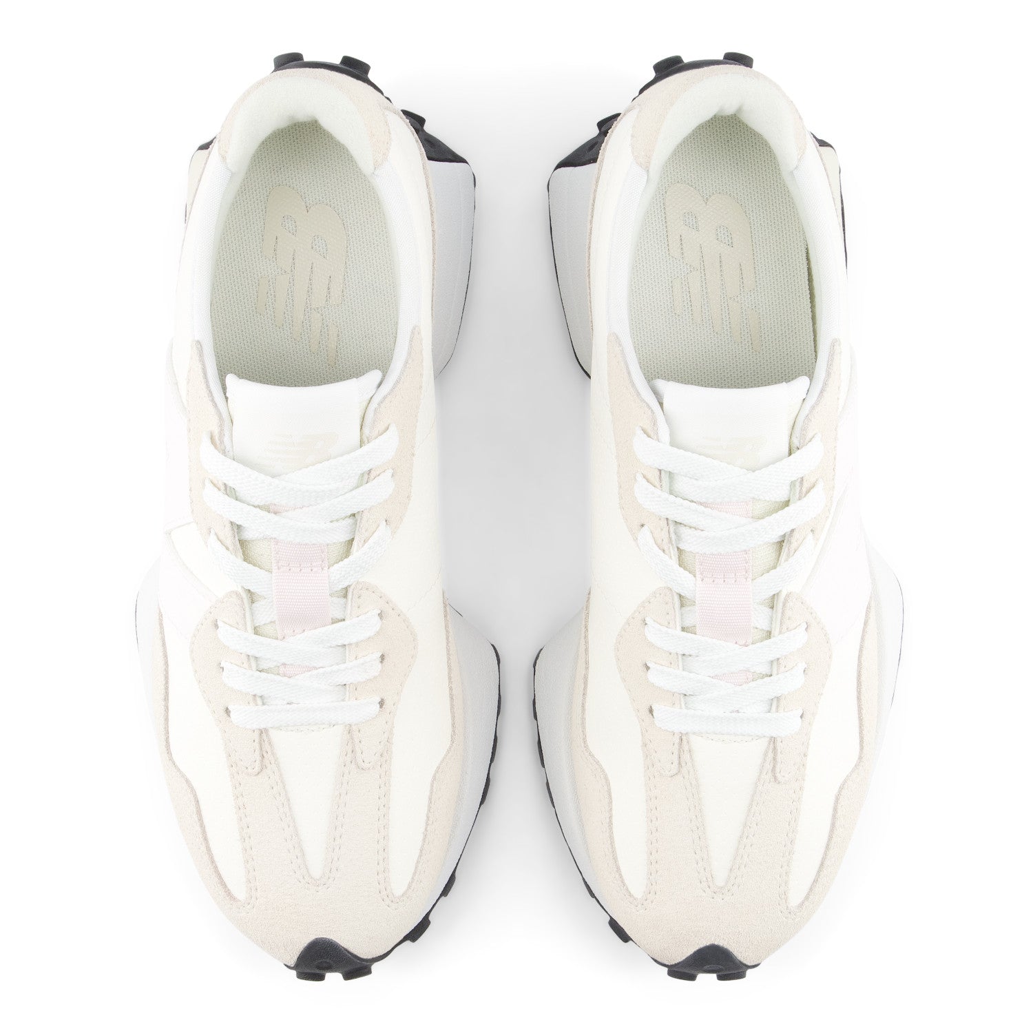 White sneakers with black soles on a white background