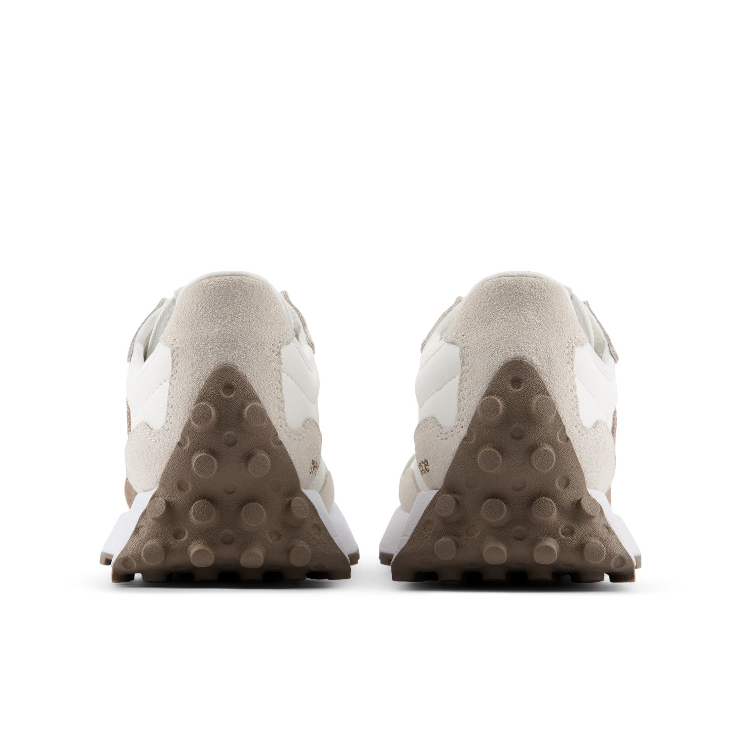Back view of beige sneakers with brown soles on a white background