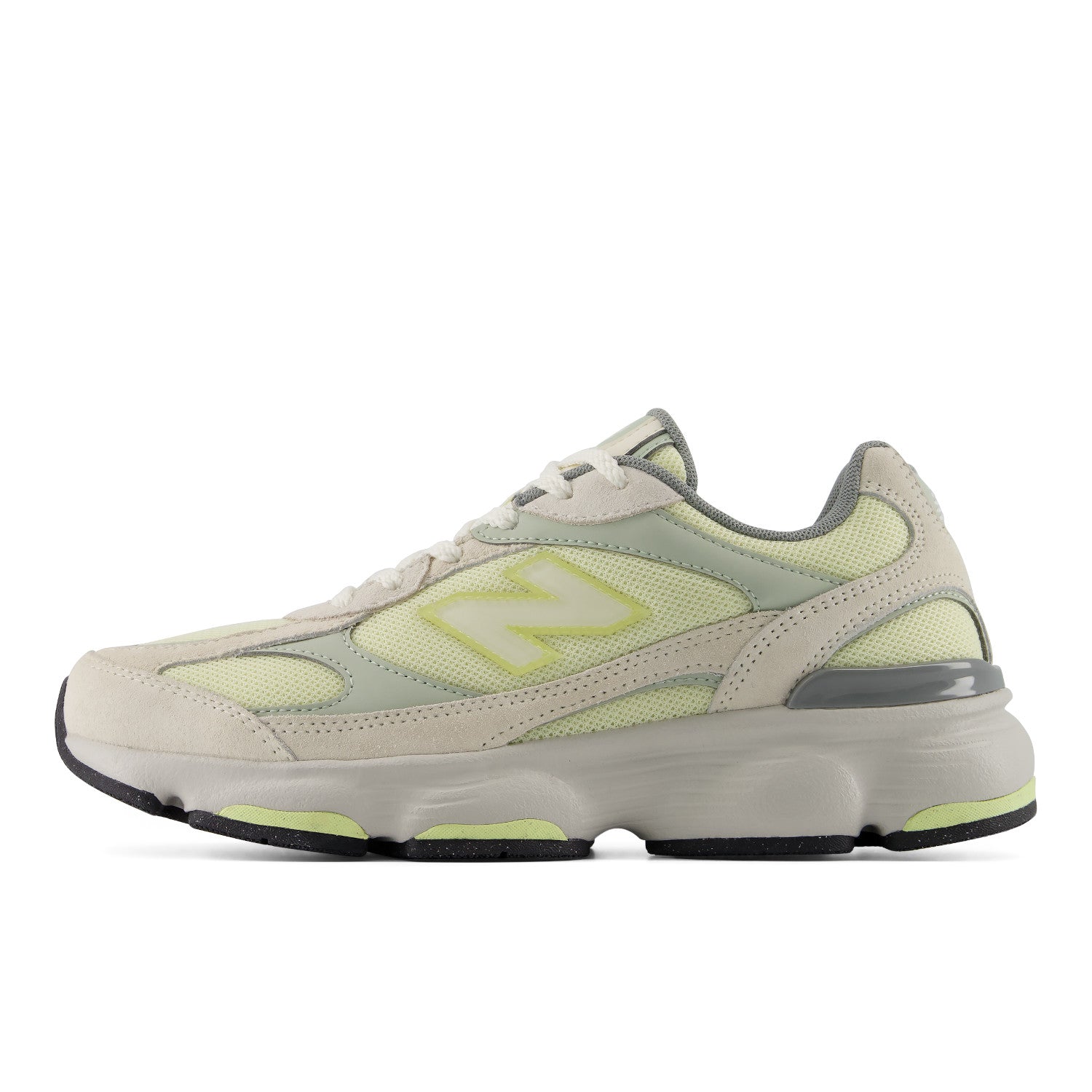 Beige and green sneaker with New Balance logo on a white background