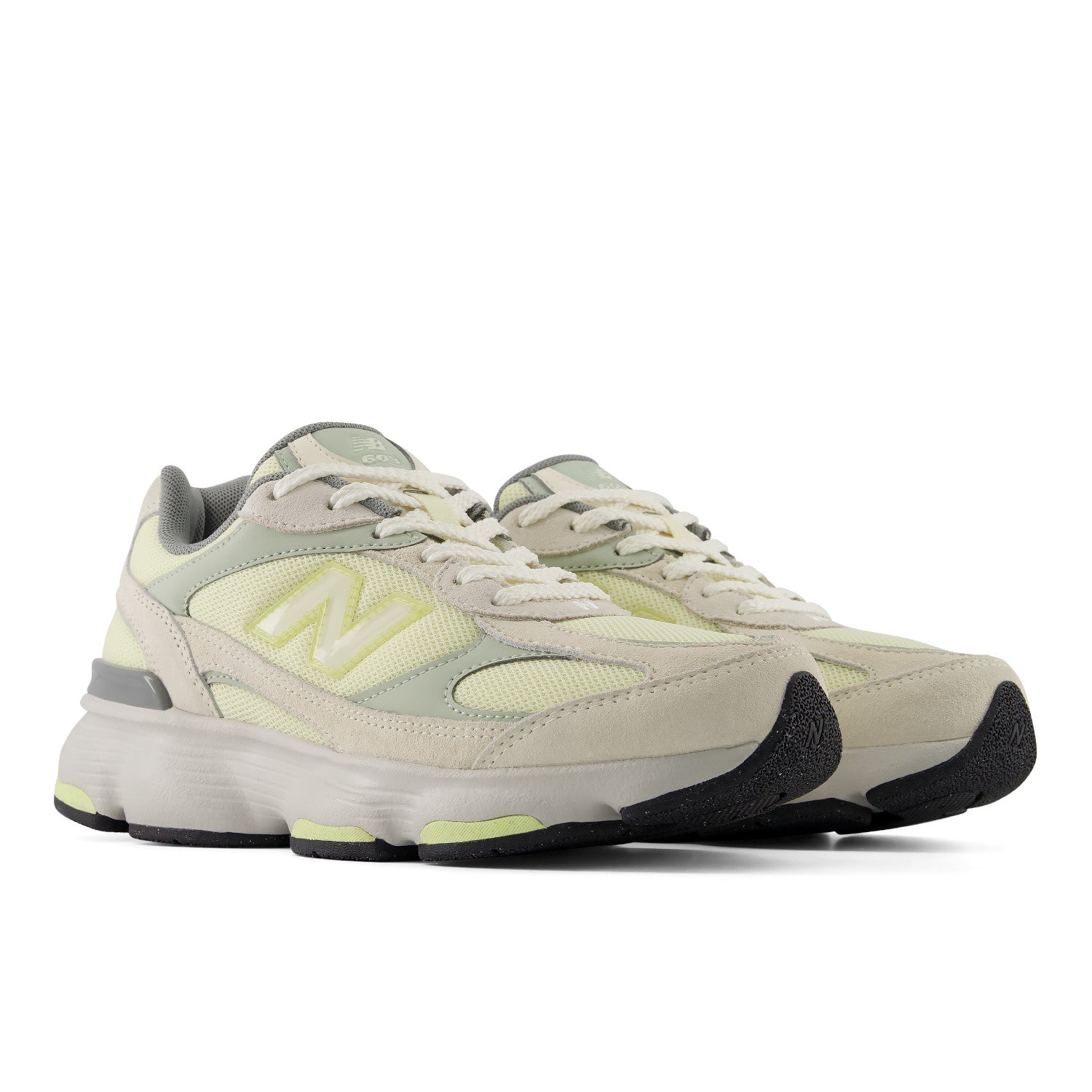 Pair of light gray sneakers with black soles on a white background