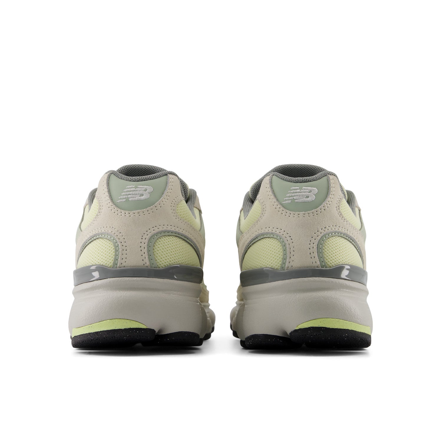 Pair of beige and green sneakers on a white background