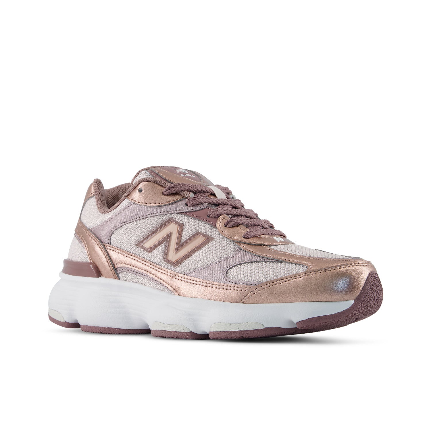 A New Balance sneaker in metallic rose gold and light pink mesh with a white midsole, shown from a side profile on a white background.