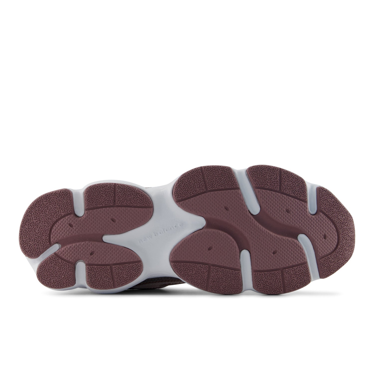 The outsole of a sneaker shown from a top-down view, featuring a chunky design with dark burgundy textured rubber and a white midsole.