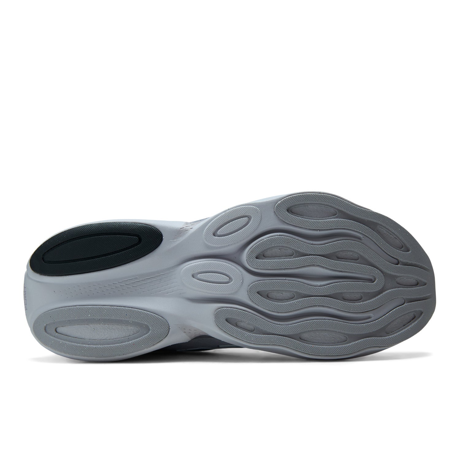 The outsole of a gray and black sneaker, showing the textured tread pattern and cushioned compartments, photographed on a clean white background.