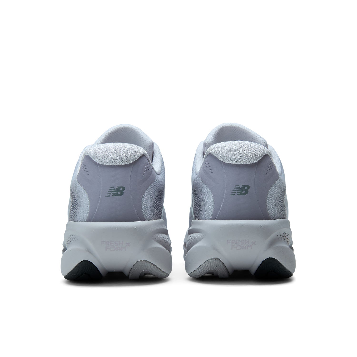 A pair of New Balance sneakers shown from the back, featuring a light gray and white design with dark gray accents and black outsole tips, set against a plain white background.